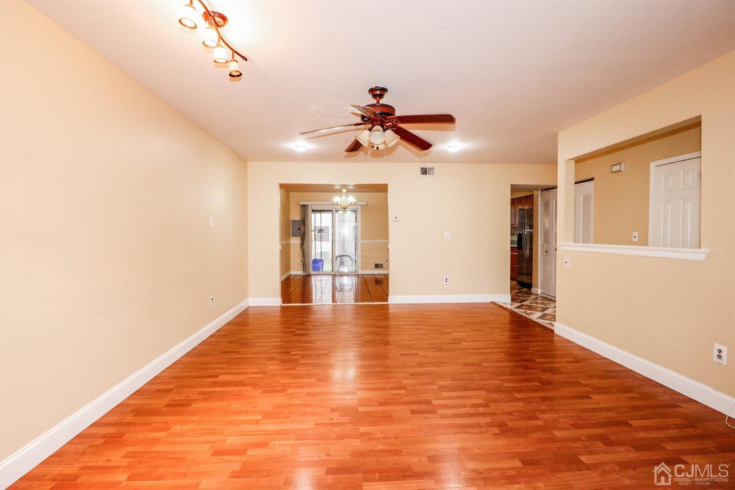 5602 Hana Road Edison, NJ 08817 - Photo 16 of 29 a view of an empty room with window and wooden floor