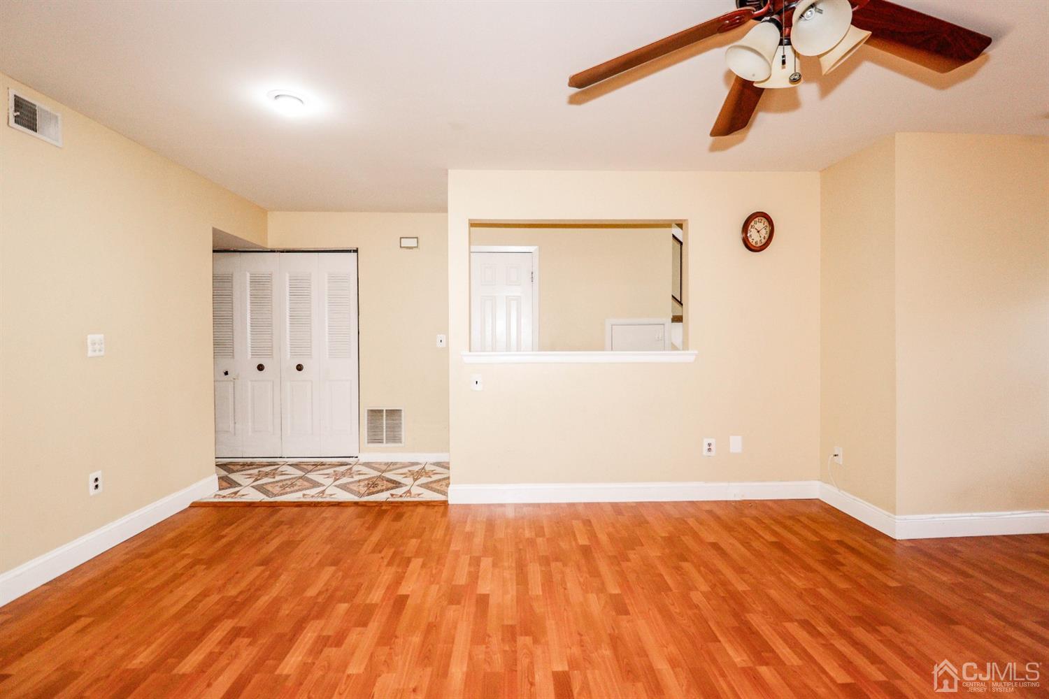 5602 Hana Road Edison, NJ 08817 - Photo 17 of 29 a view of a room with wooden floor and white walls