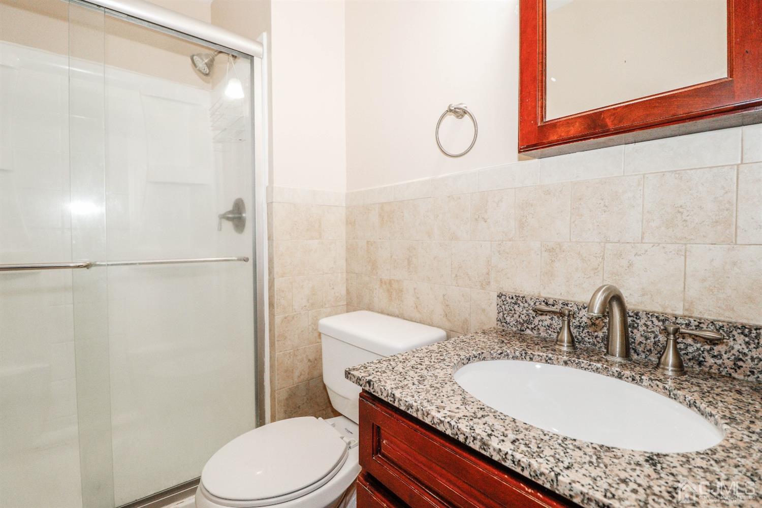 5602 Hana Road Edison, NJ 08817 - Photo 20 of 29 a bathroom with a granite countertop sink mirror vanity and toilet