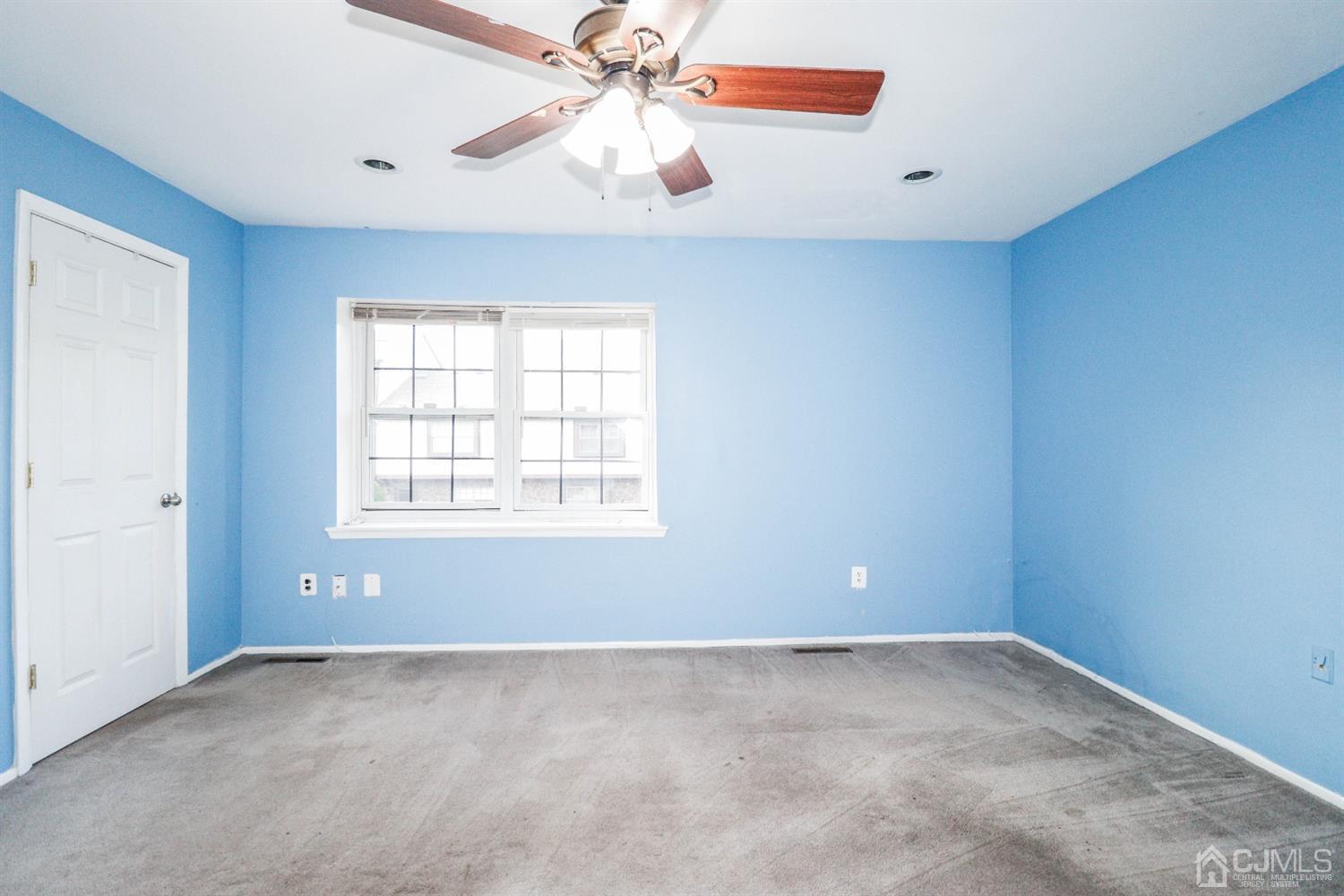 5602 Hana Road Edison, NJ 08817 - Photo 22 of 29 an empty room with a window and a fan