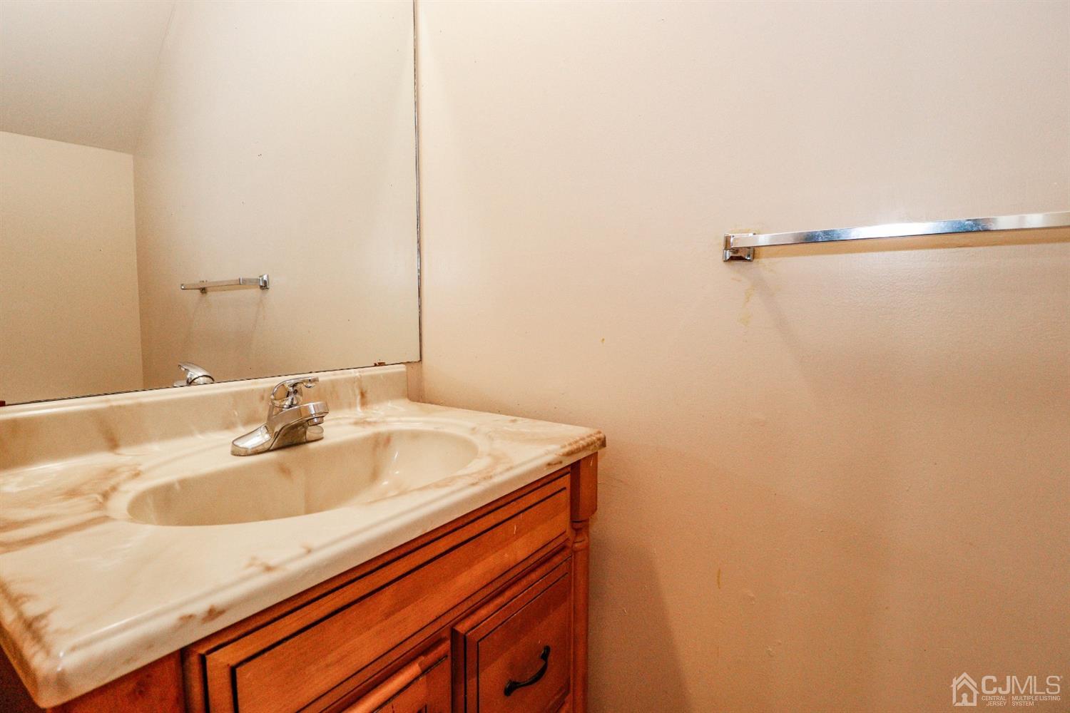 5602 Hana Road Edison, NJ 08817 - Photo 29 of 29 a bathroom with a sink and a mirror