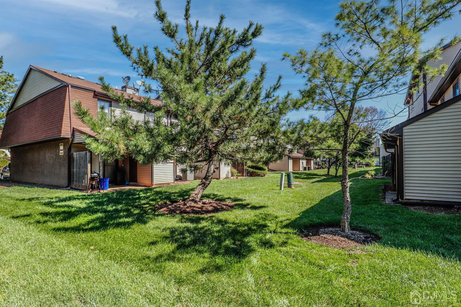5602 Hana Road Edison, NJ 08817 - Photo 5 of 29 a view of a house with a big yard and large trees
