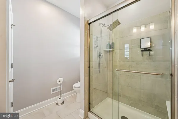 a bathroom with a shower and a sink