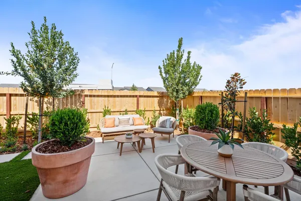 a outdoor living space with furniture potted plant and a large window