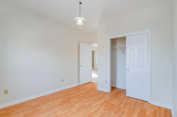 a view of empty room with wooden floor