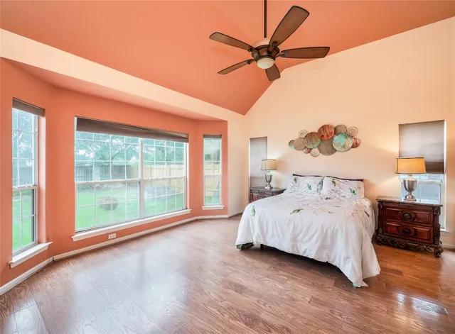 a bedroom with a large bed and a large window