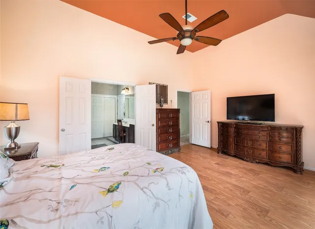 a bedroom with a bed and a flat screen tv