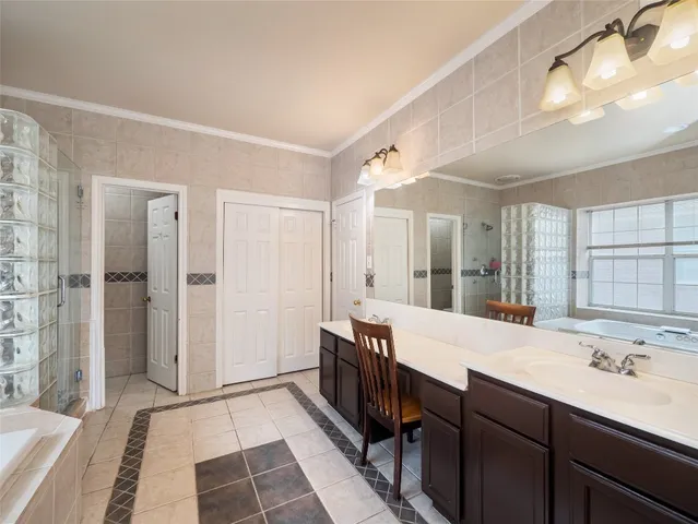 a large bathroom with a double vanity sink and a large mirror