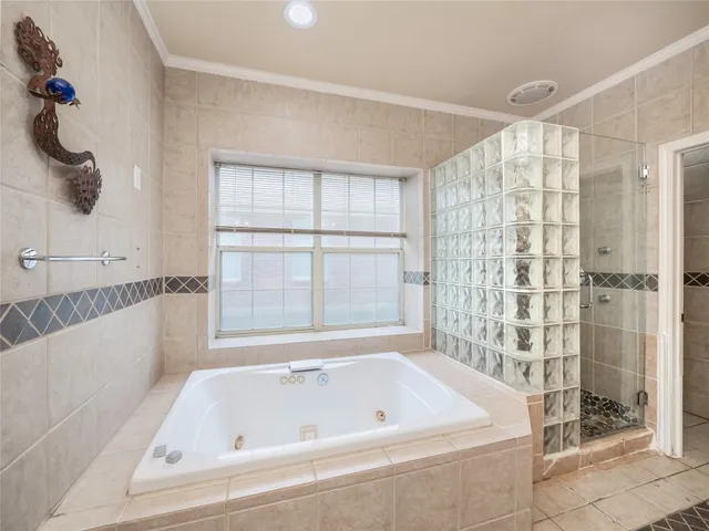 a bathroom with a bathtub and shower