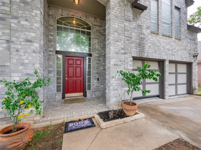 a building with potted plants in front of door