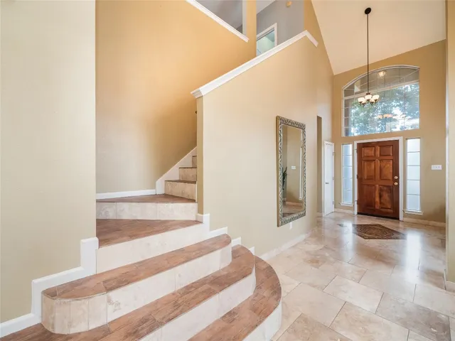 a view of a hallway with wooden floor and entryway