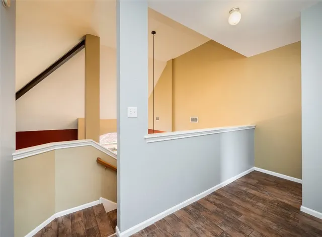 a view of hallway with wooden floor
