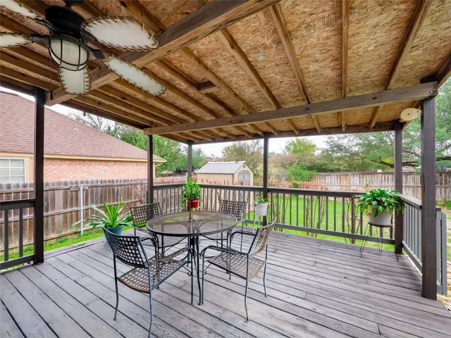 a view of a backyard with table and chairs and a fire pit