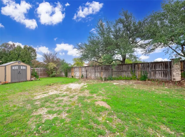a view of a house with a yard and sitting area
