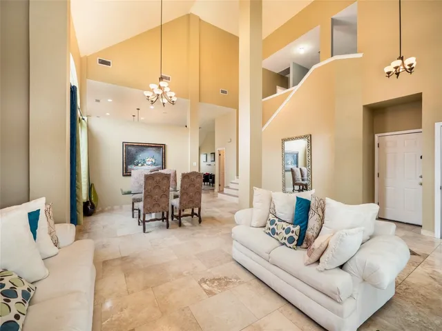 a living room with furniture and a chandelier