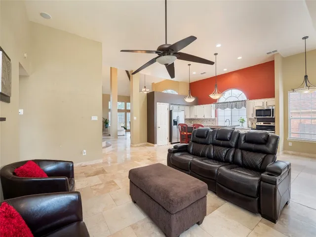 a living room with furniture and a chandelier