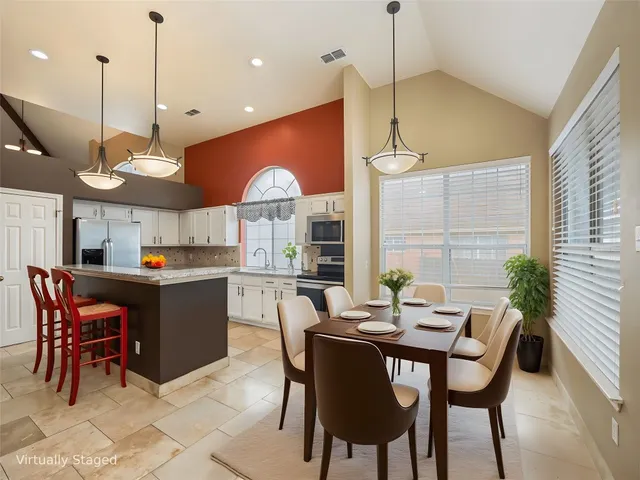 a kitchen with a table and chairs in it