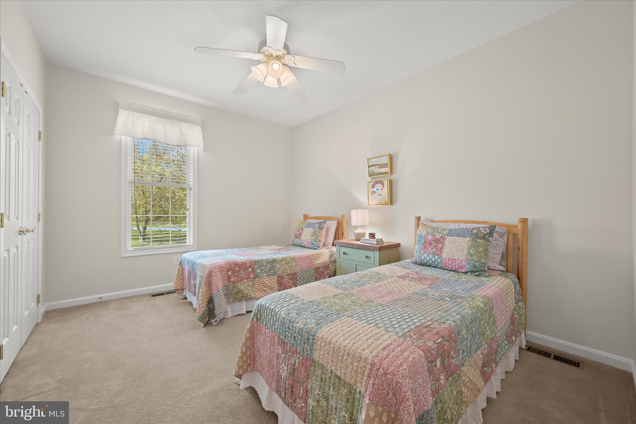 6735 Mink Hollow Road Highland, MD 20777 - Photo 30 of 58 a bedroom with two beds and a chandelier