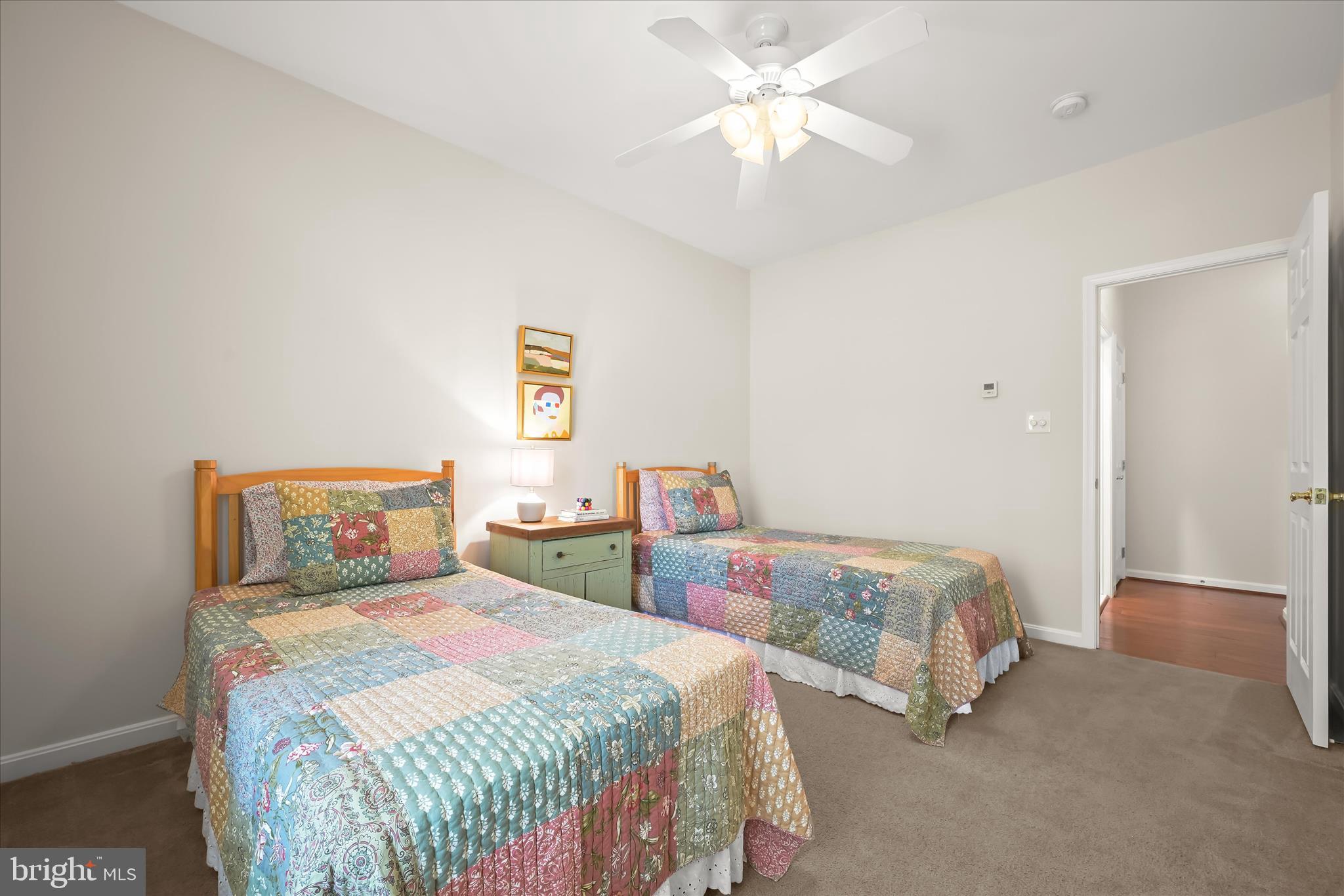 6735 Mink Hollow Road Highland, MD 20777 - Photo 31 of 58 a bedroom with two beds and a chandelier