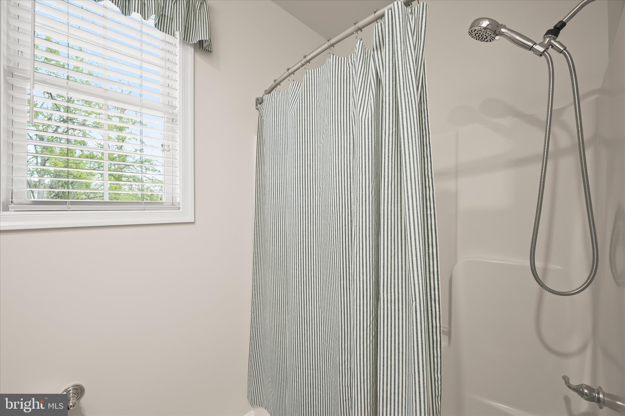 6735 Mink Hollow Road Highland, MD 20777 - Photo 35 of 58 a bathroom with a shower and a window