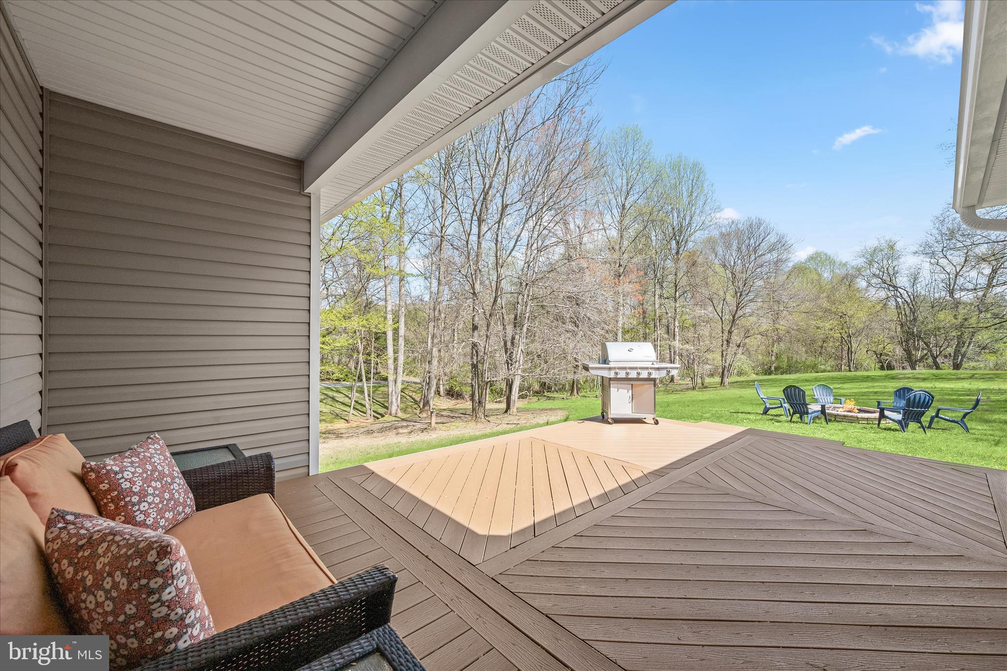 6735 Mink Hollow Road Highland, MD 20777 - Photo 42 of 58 a view of a patio with couches chairs and a yard