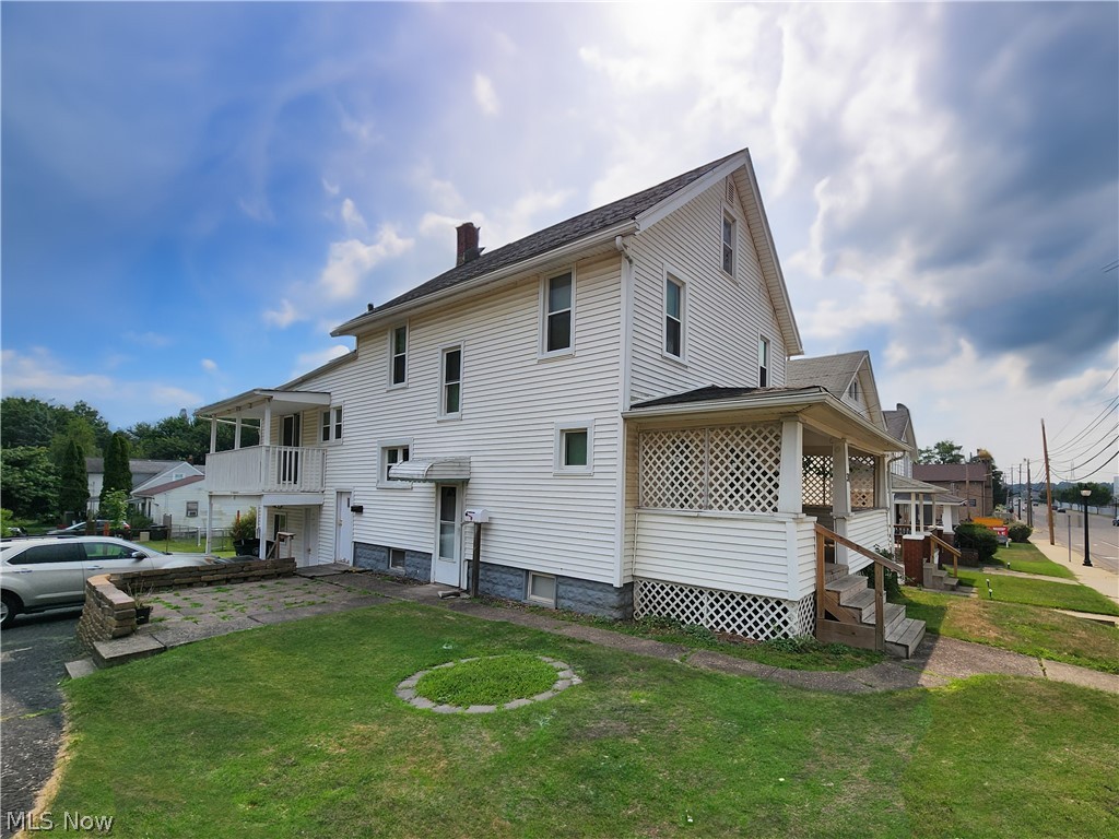 30 West Wilbeth Road, Unit A Akron, OH 44301 - Photo 16 of 16 Rear view of house with a balcony and a yard