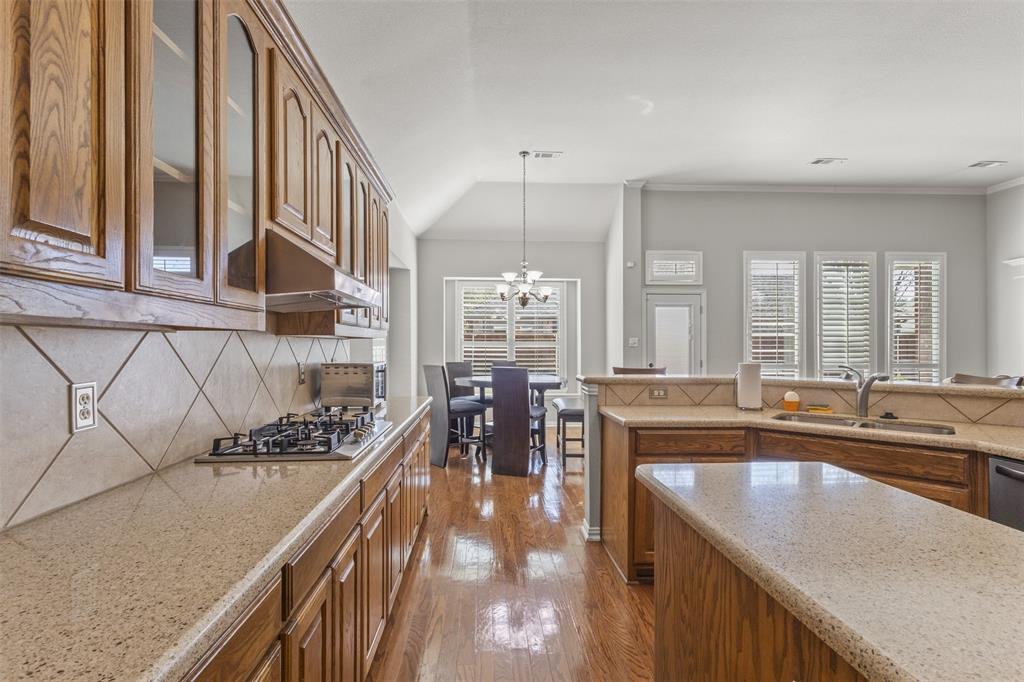 1906 Armstrong Drive Allen, TX 75002 - Photo 18 of 39 a kitchen with counter top space a sink and appliances
