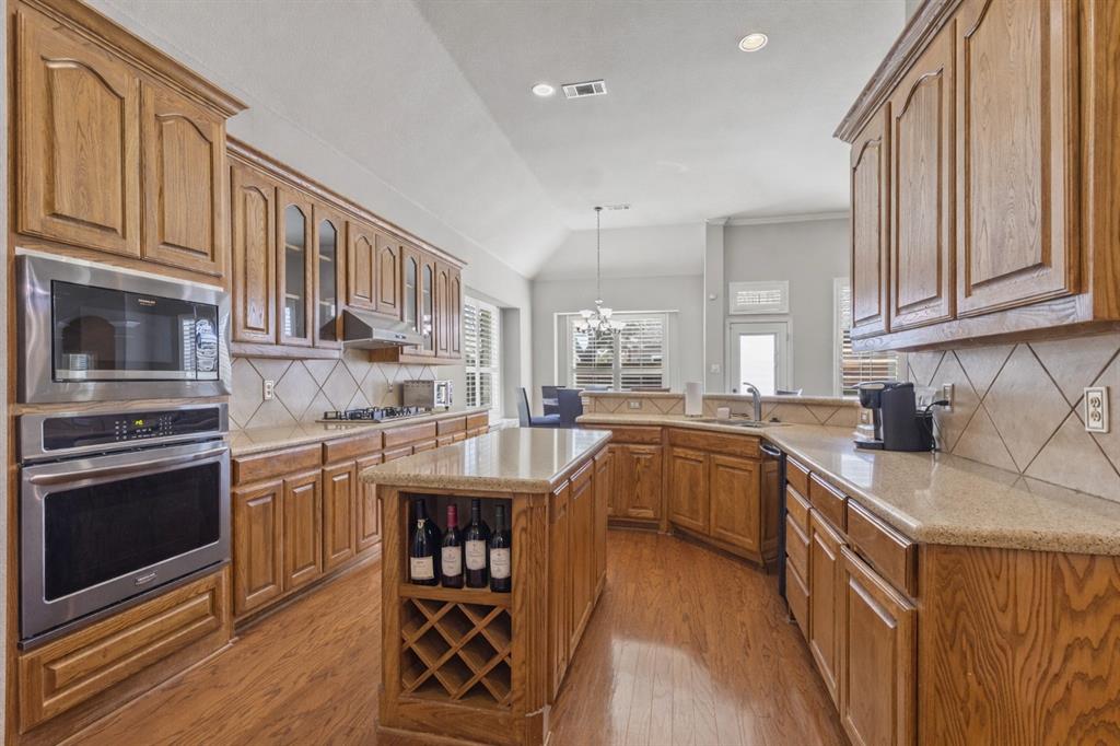 1906 Armstrong Drive Allen, TX 75002 - Photo 19 of 39 a kitchen with granite countertop a sink stove and cabinets