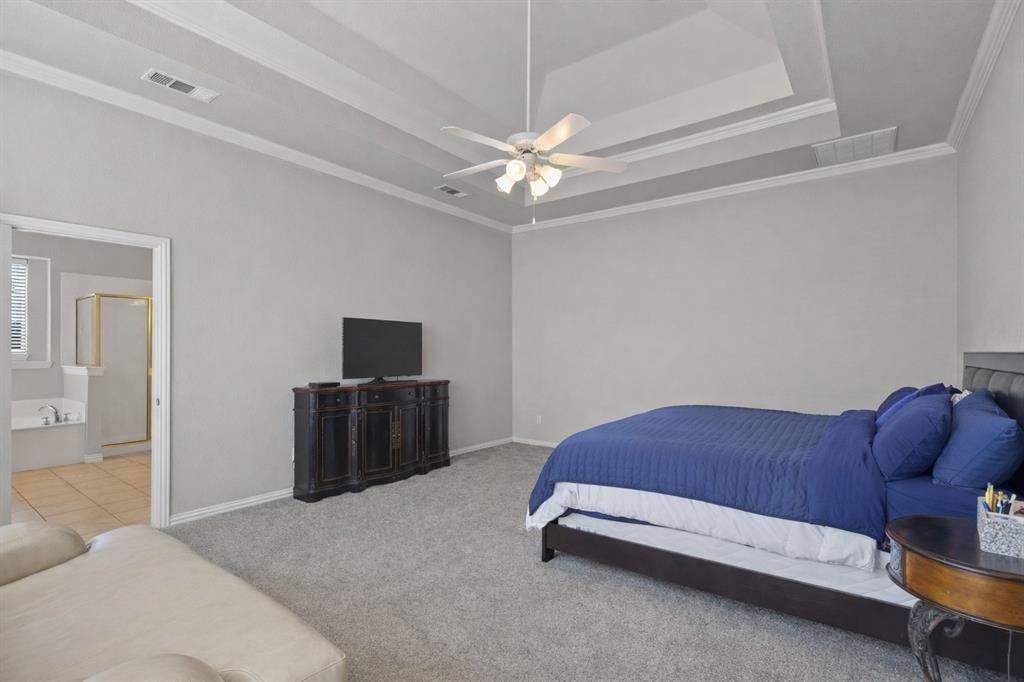 1906 Armstrong Drive Allen, TX 75002 - Photo 20 of 39 a bedroom with a bed and a television