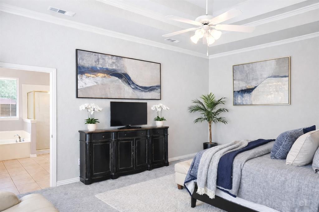 1906 Armstrong Drive Allen, TX 75002 - Photo 21 of 39 a bedroom with a bed and a flat screen tv