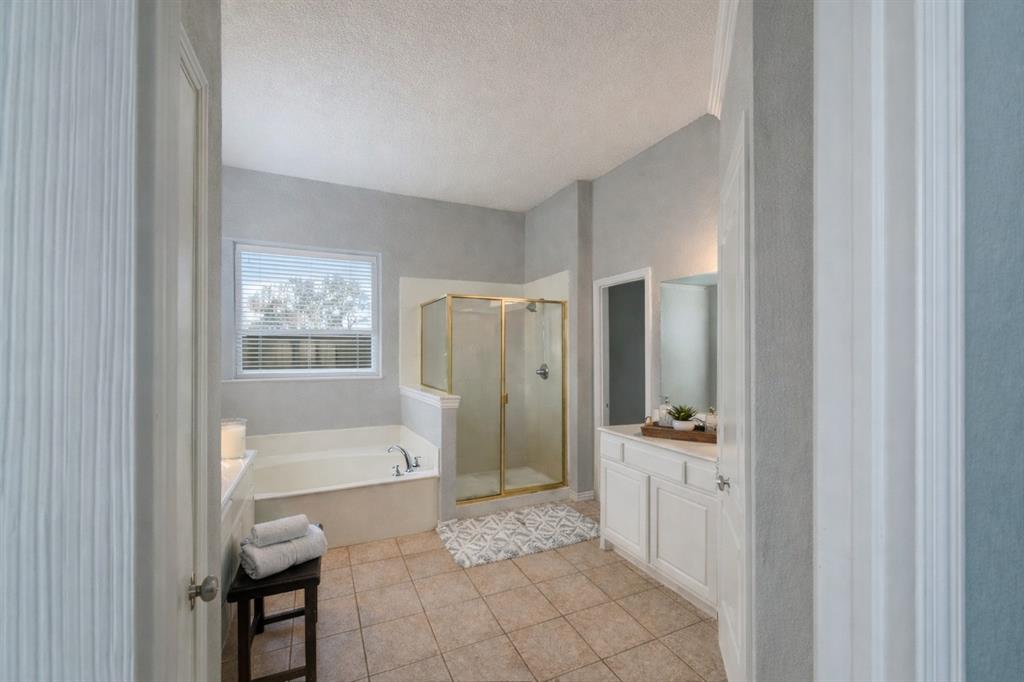 1906 Armstrong Drive Allen, TX 75002 - Photo 23 of 39 a bathroom with a tub shower and a sink
