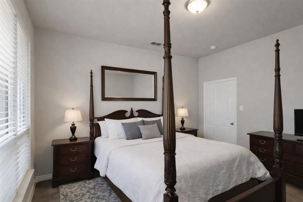 1906 Armstrong Drive Allen, TX 75002 - Photo 26 of 39 a bedroom with a bed and a mirror