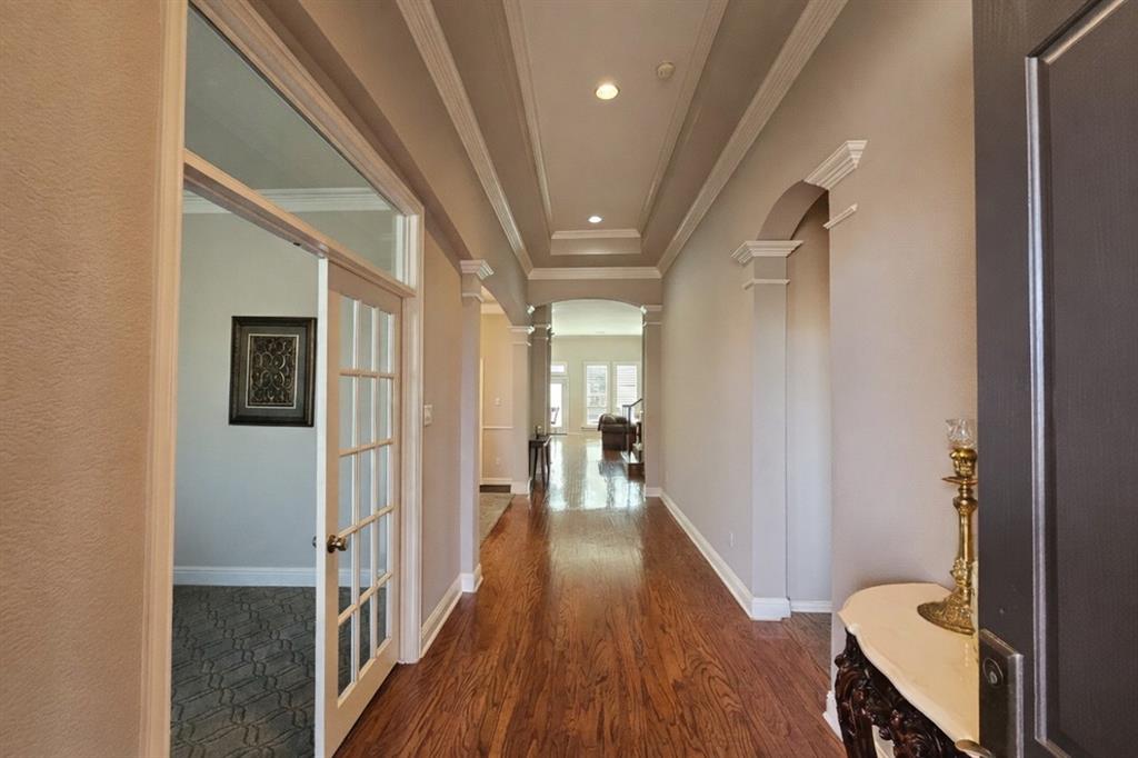1906 Armstrong Drive Allen, TX 75002 - Photo 8 of 39 a view of a hallway with wooden floor and staircase