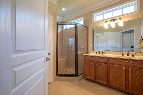 a bathroom with a double vanity sink and mirror