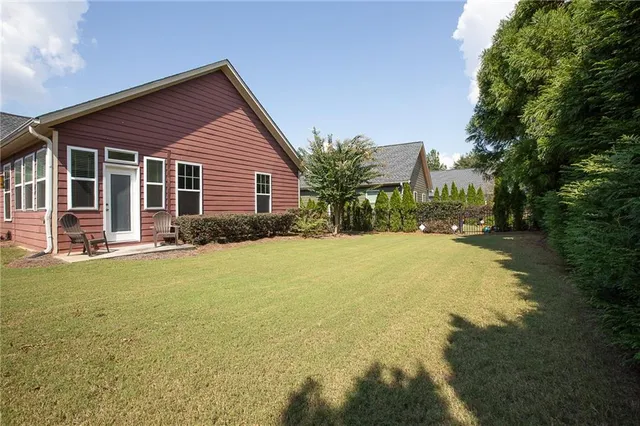 a view of a house with a yard and garage