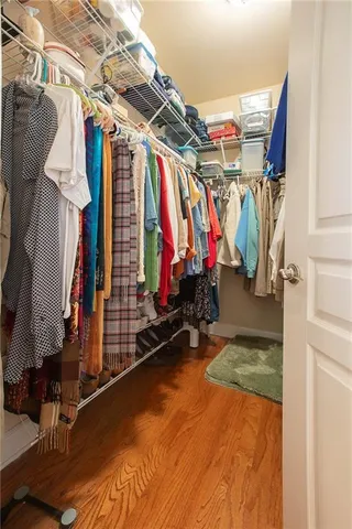 a view of walk in closet with clothes