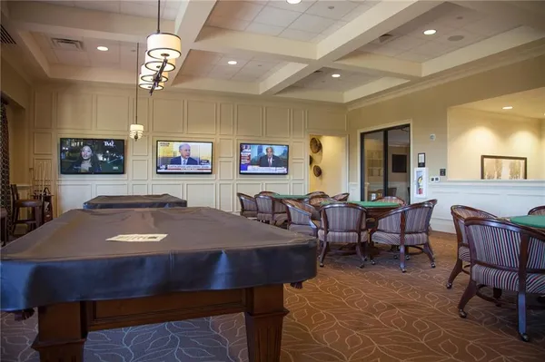 a living room with furniture a chandelier and a dining room