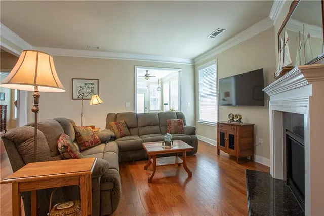 a living room with furniture a flat screen tv and a fireplace