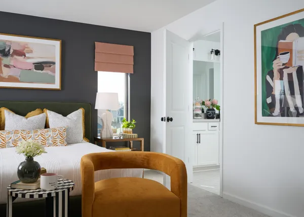 a bedroom with bed and a painting on the wall