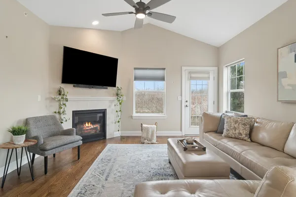 a living room with furniture a flat screen tv and a fireplace