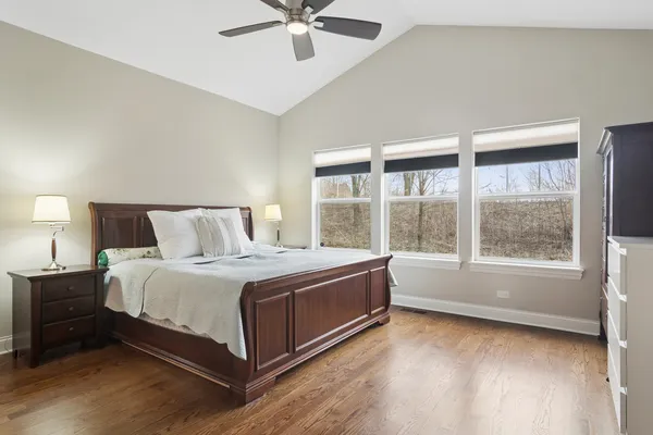 a spacious bedroom with a bed and a window