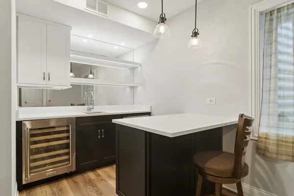 a kitchen with a sink cabinets and wooden floor