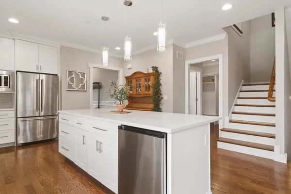 a kitchen with stainless steel appliances a refrigerator and a stove top oven