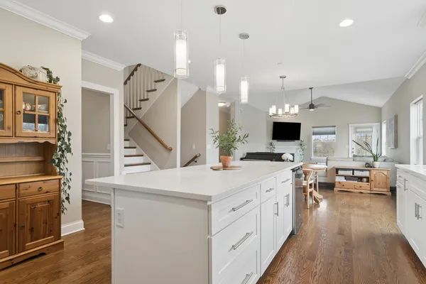 a large kitchen with cabinets and wooden floor