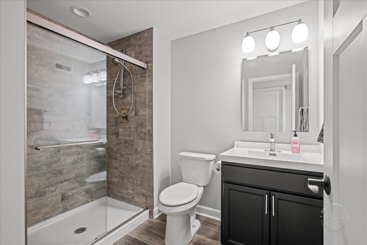 1909 Constitution Street Sycamore, IL 60178 - Photo 22 of 39 a bathroom with a sink toilet and shower