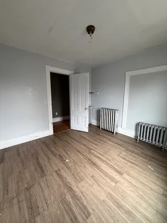 a view of front door with wooden floor