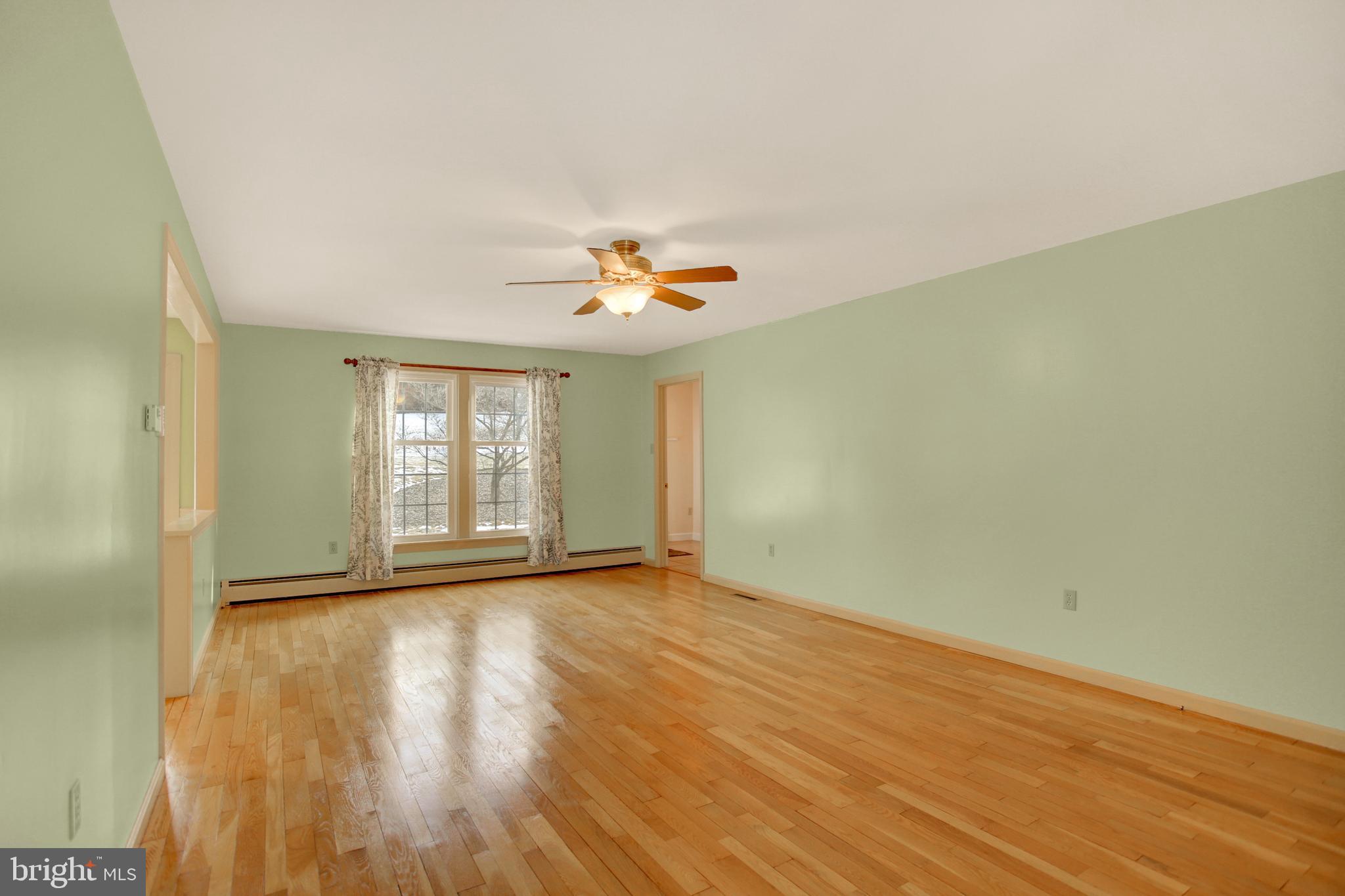 202 South Ridge Road Boiling Springs, PA 17007 - Photo 14 of 36 a view of an empty room with wooden floor and a window