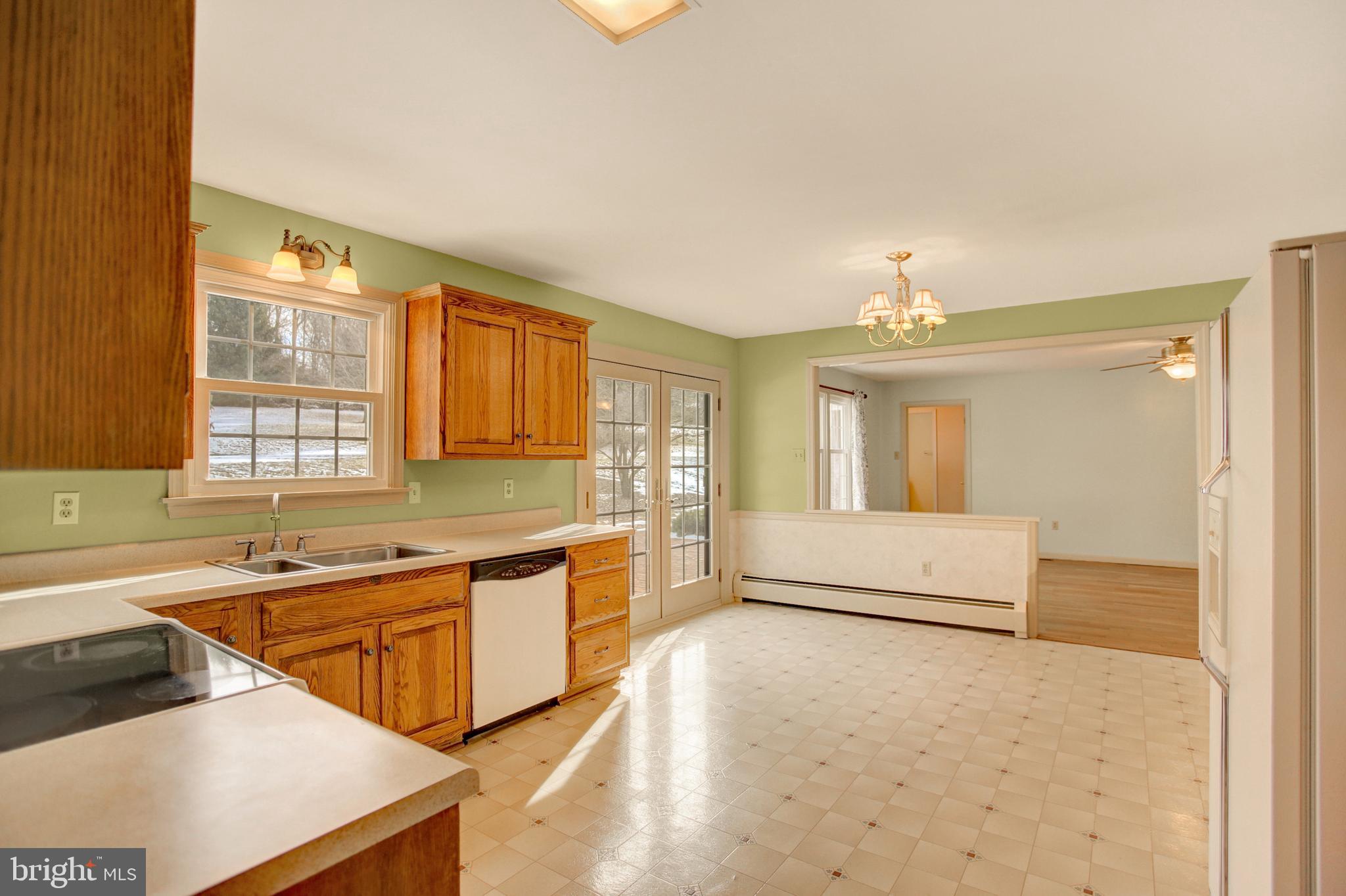 202 South Ridge Road Boiling Springs, PA 17007 - Photo 10 of 36 a large white kitchen with a sink and dishwasher a stove with wooden floor