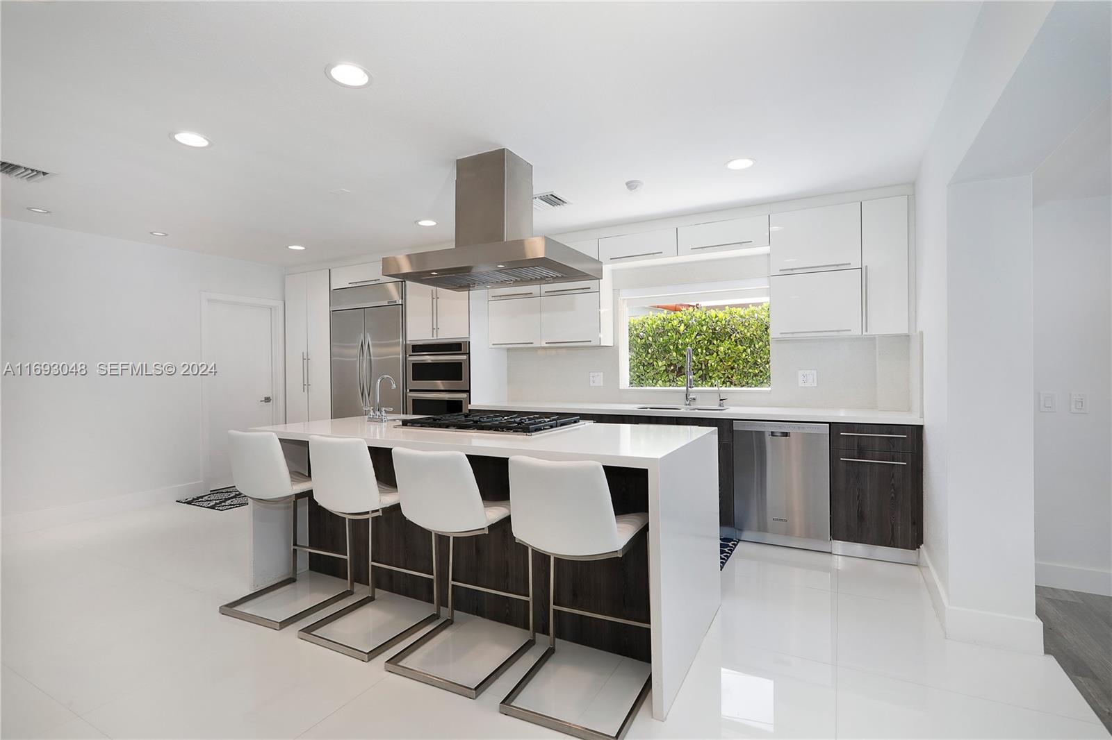 9611 Southwest 59th Terrace Miami, FL 33173 - Photo 11 of 32 a kitchen with a dining table chairs and a window