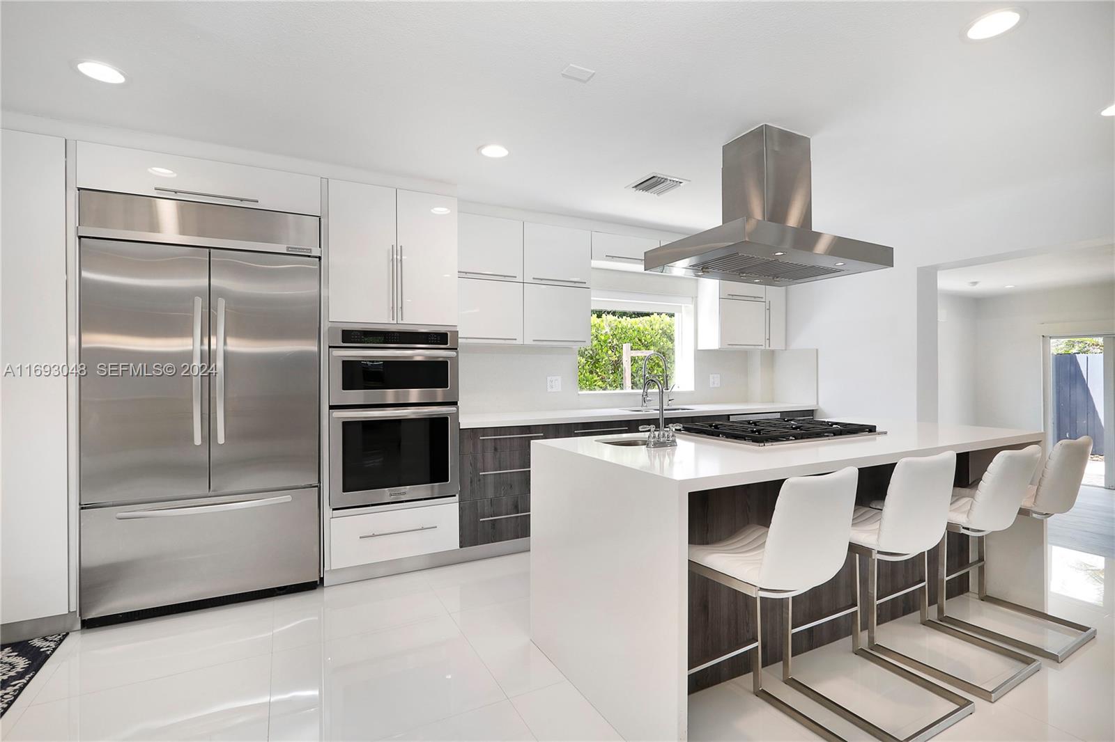 9611 Southwest 59th Terrace Miami, FL 33173 - Photo 13 of 32 a kitchen with a stove a refrigerator and furniture